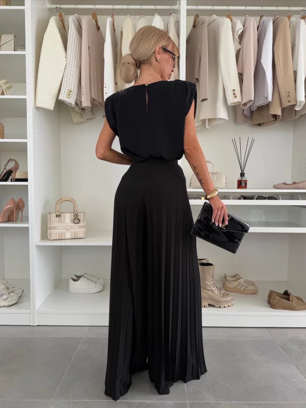 Two-piece women's apparel set featuring a pleated top and wide-leg trousers for versatile fashion.