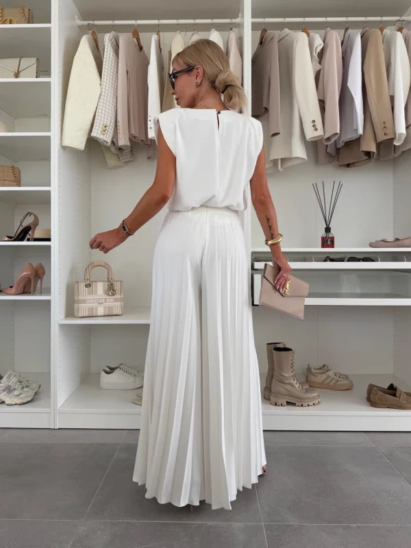 Detailed view of the soft stretch fabric of the women's pleated trousers and top set.