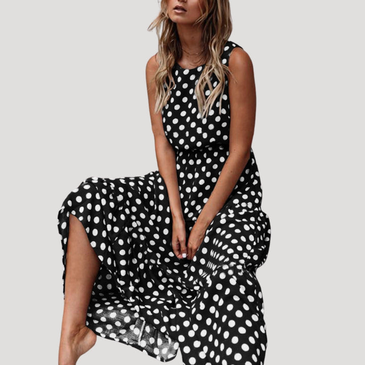 Flowy polka dot sleeveless midi dress for women, with a round neck. Ideal for comfortable, stylish summer days.