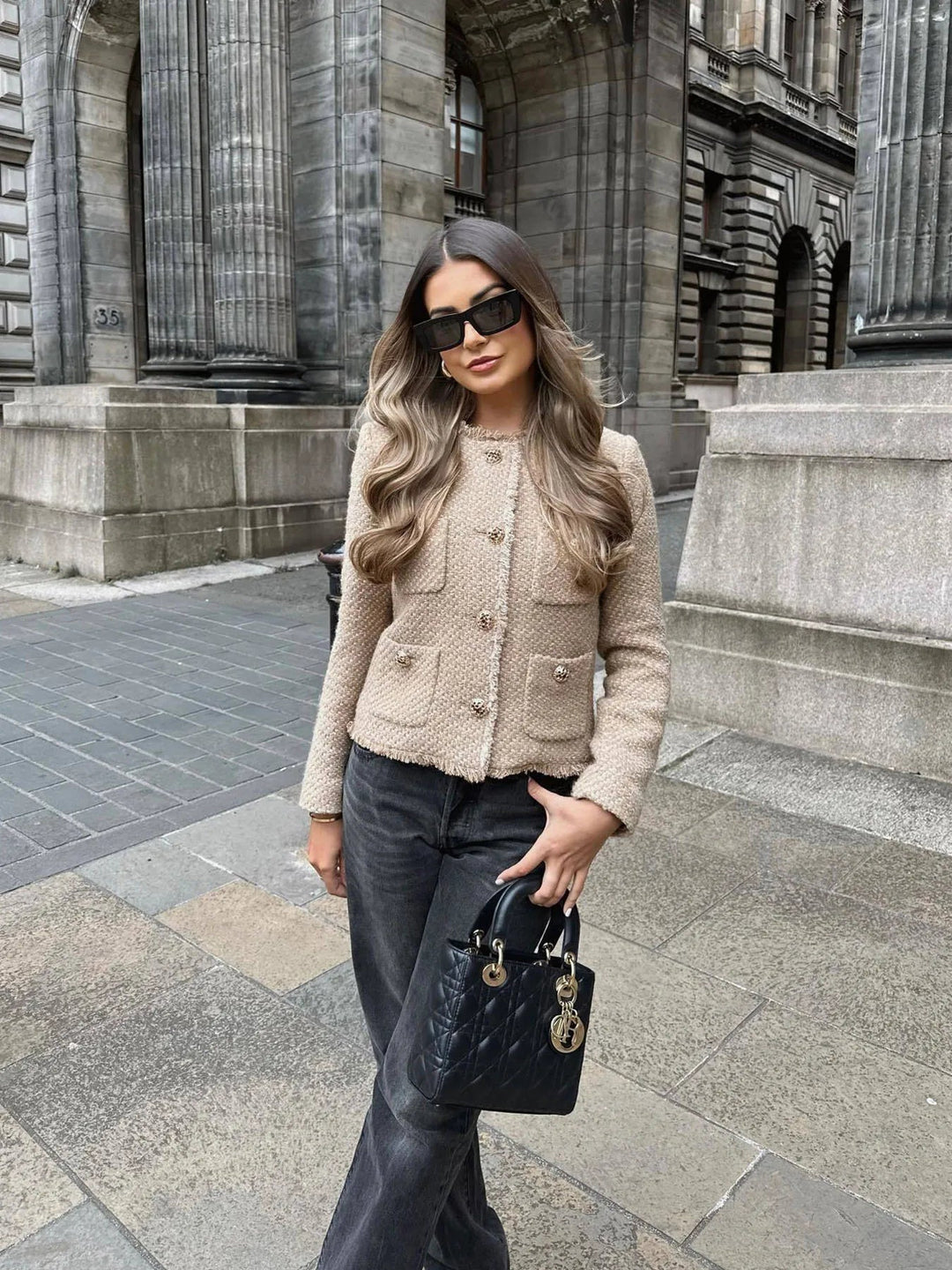 Casual yet sophisticated women's short tweed blazer with unique buttons, a trendy outerwear piece.