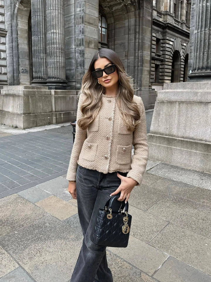 Casual yet sophisticated women's short tweed blazer with unique buttons, a trendy outerwear piece.