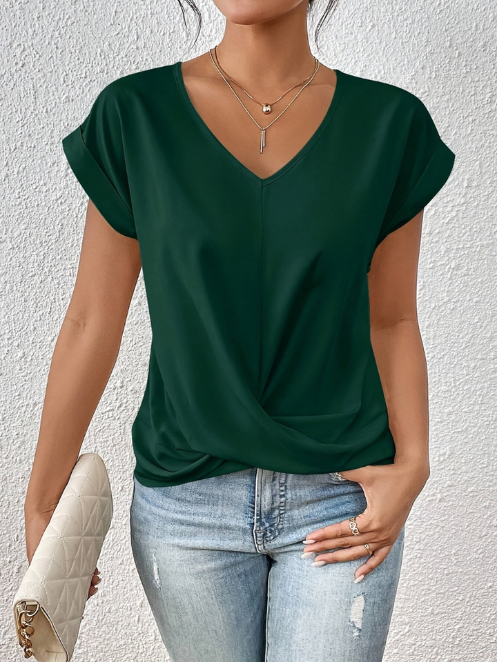 Women's elegant V-neck short sleeve blouse with a twist-front. Perfect for office casual & everyday chic.