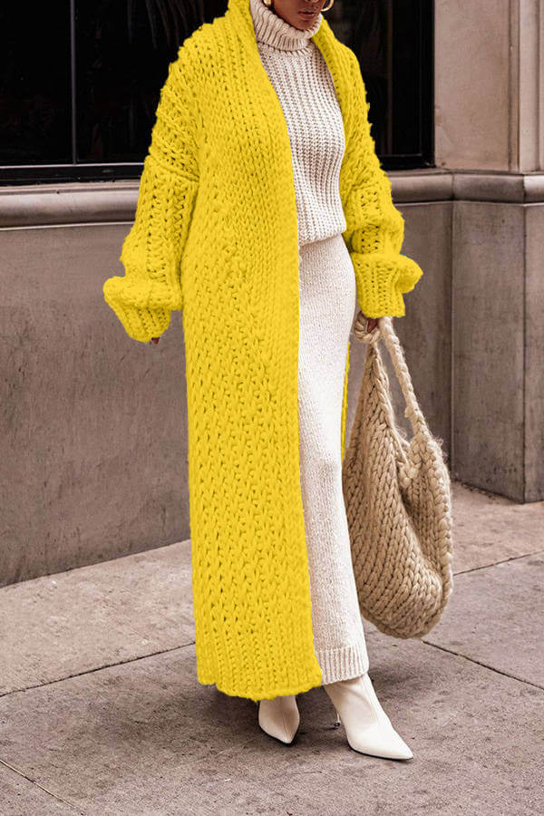 Studio shot of women's luxurious knit cardigan sweater set, emphasizing its soft texture