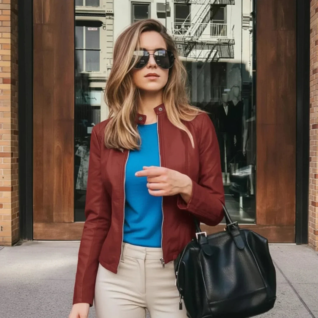 Black women's fitted zip-up jacket. Chic modern outerwear with a sleek collarless design, ideal for fashion.