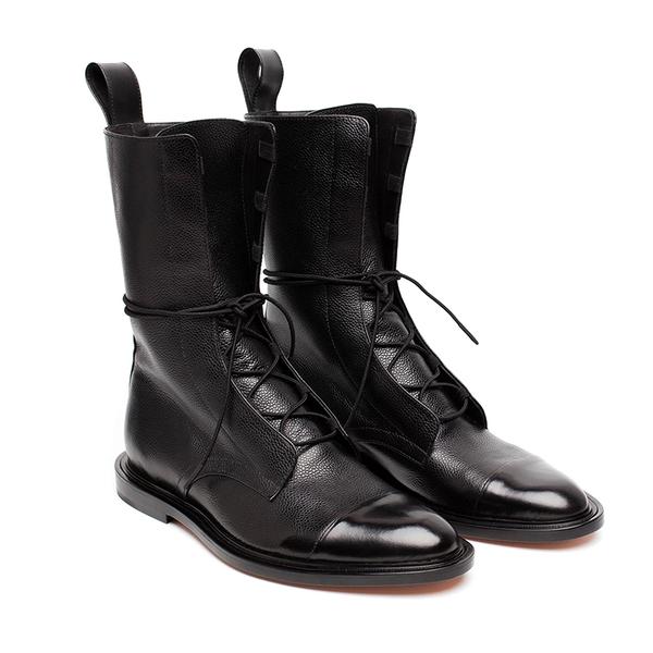 Close-up of women's fashion ankle boots, black lace-up design with durable construction. Classic footwear.