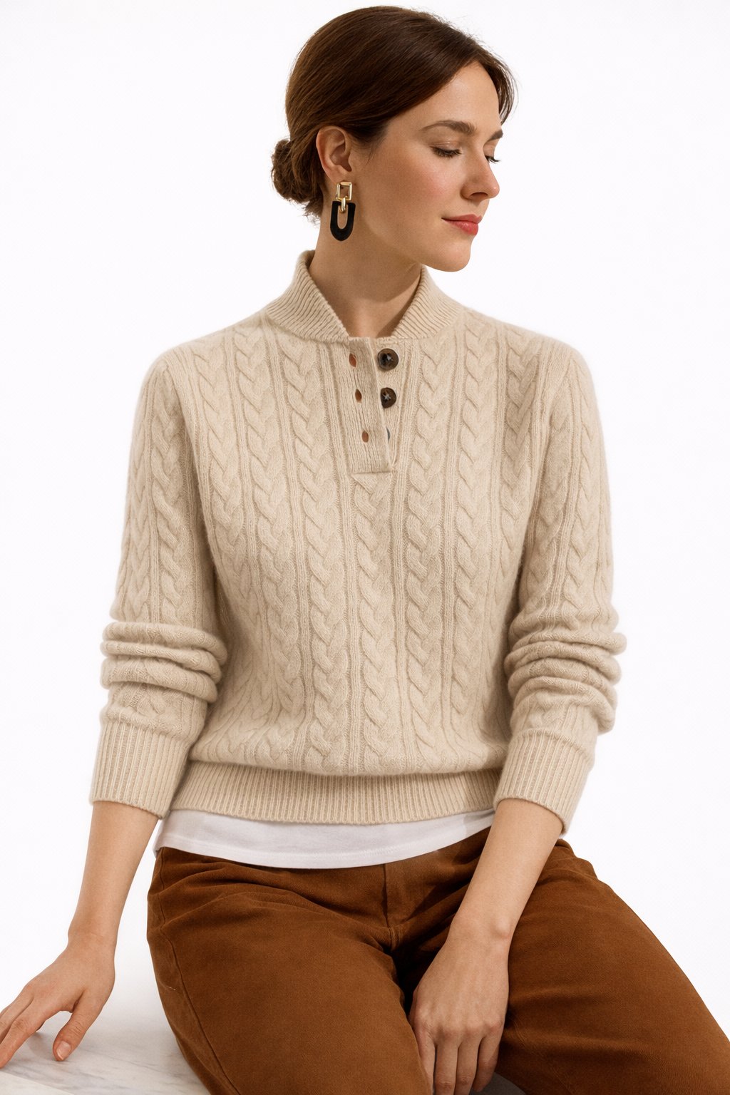 Classic women's cable knit pullover sweater. Elegant long sleeve button-neck top for fall/winter smart casual style.