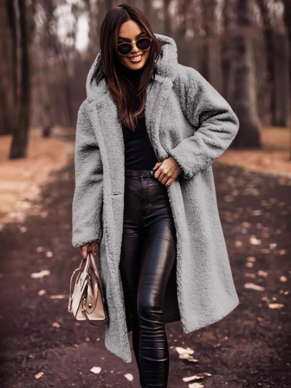 Women's long trench coat, double-breasted with a stylish belt. Elegant outerwear for fall and winter fashion.