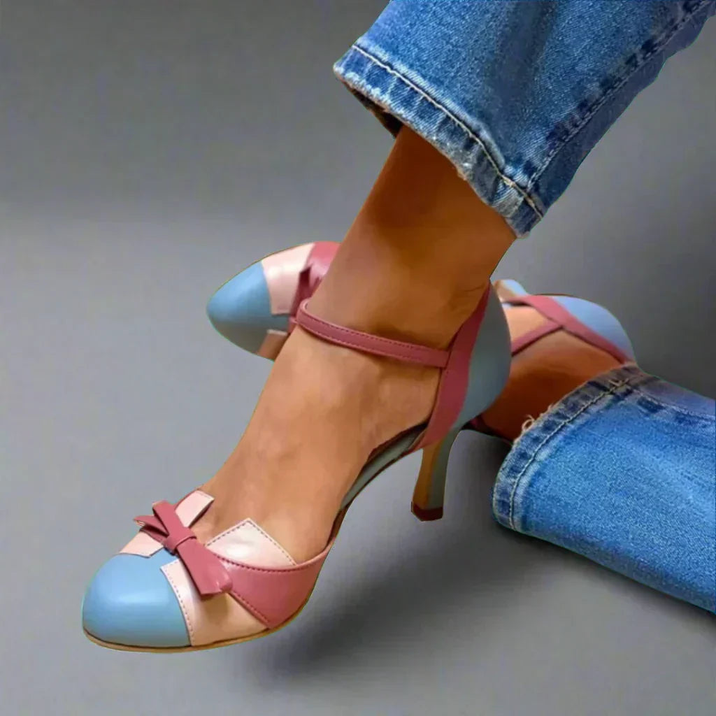 Women's classic mid-heel pumps with elegant bow strap. Perfect for formal events or comfortable dress wear.