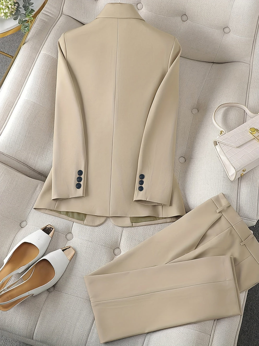 Elegant women's pantsuit with notched lapel blazer, a chic and professional tailored outfit for work.