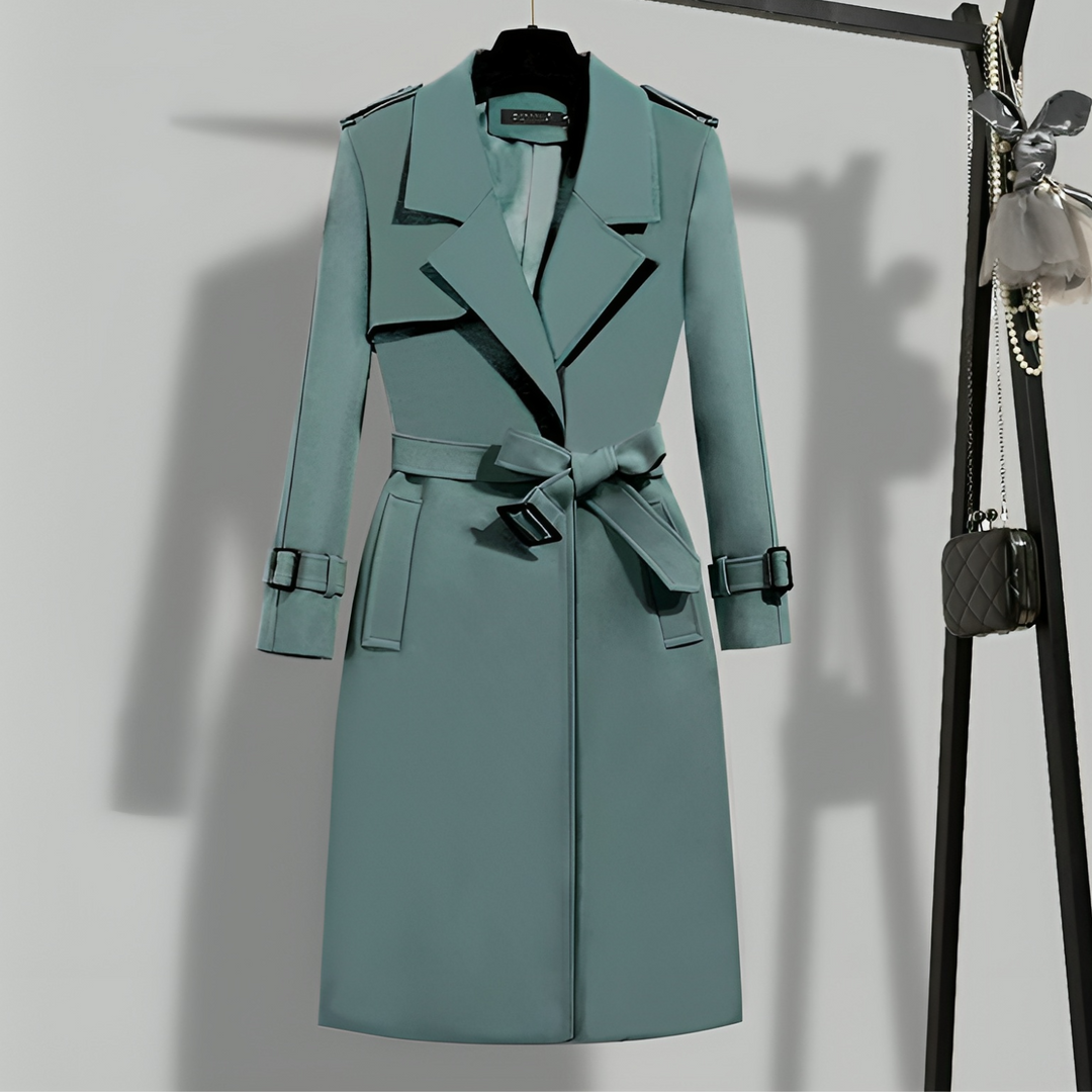 Long women's trench coat, sophisticated with a belted waist and buttoned front. Ideal for versatile fall fashion.