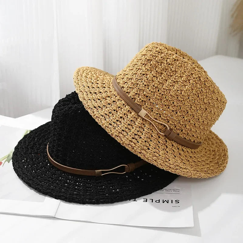 High-angle view of a women's classic woven fedora hat, featuring a trendy faux leather trim.