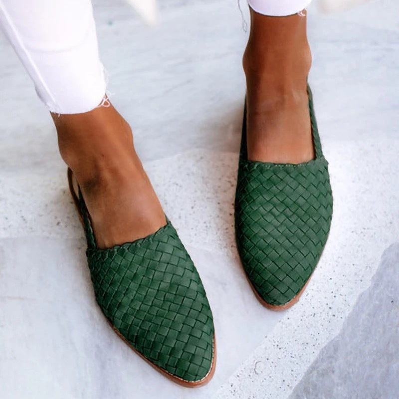 Chic black leather women's closed toe slip-on flat mules, comfortable smart casual footwear for ladies.