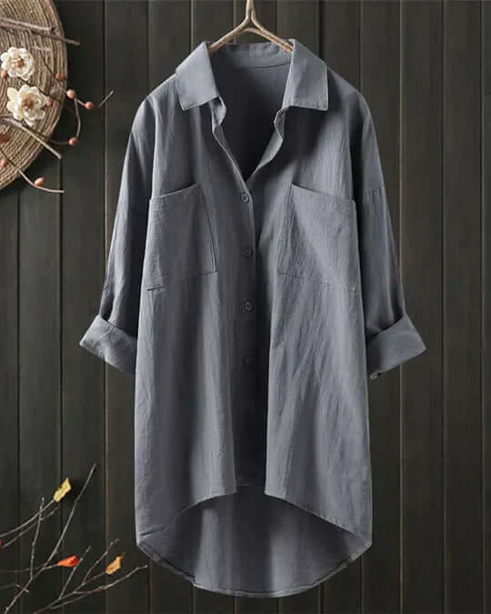 Elegant women's collared longline blouse. Double pockets, roll tab sleeves, and an oversized fit for casual wear.