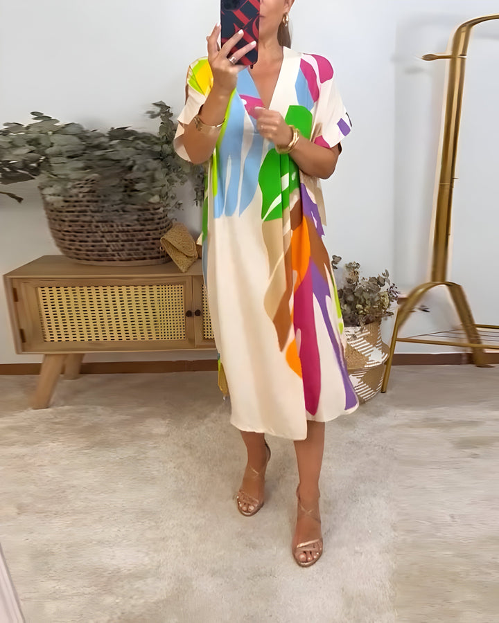 Fashionable women's abstract print shift dress with V-neck, short sleeves, a comfortable casual look.
