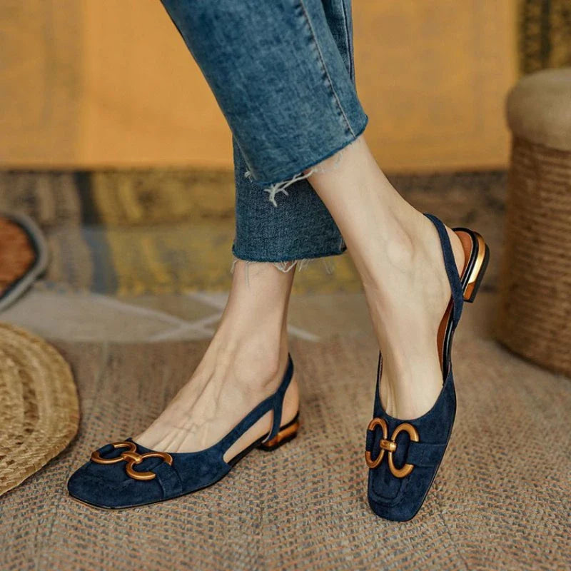 Stylish women's comfort flats with slingback strap and decorative chain for spring attire.