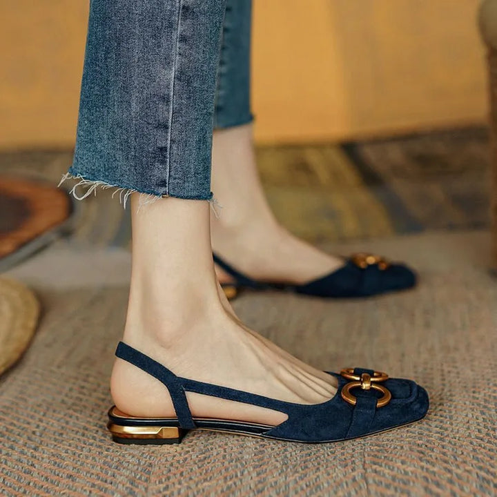 Front view of women's orthopedic slingback flats, featuring a modern chain accessory.