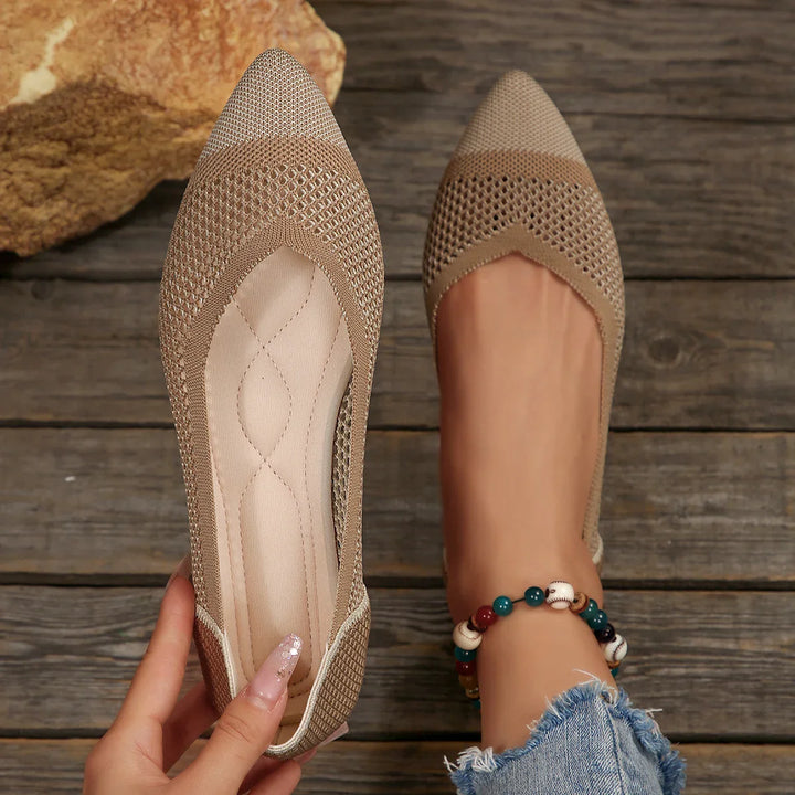 Model wearing comfortable knit pointed toe flats in grey, demonstrating a casual, stylish look.