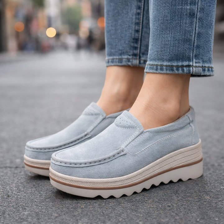 Close-up of women's black suede platform loafers, emphasizing soft texture and comfortable design