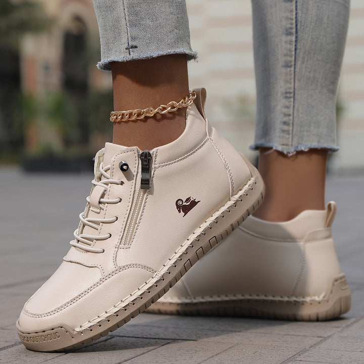 Close-up of women's zip-up walking sneakers, showcasing the easy-on zipper closure and breathable fabric.