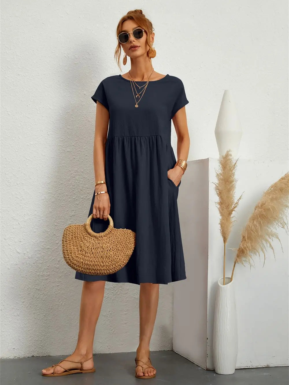 Stylish women's casual midi dress, blending fashion with practical pockets for daily activities.