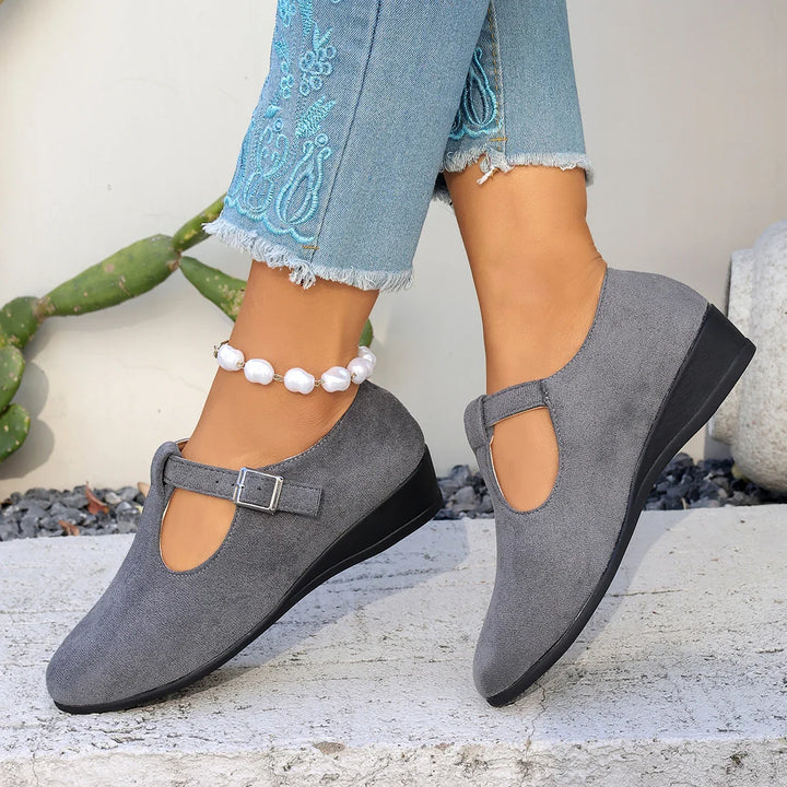 Lifestyle image of women's comfortable suede loafers with a buckle, perfect for office or casual trips