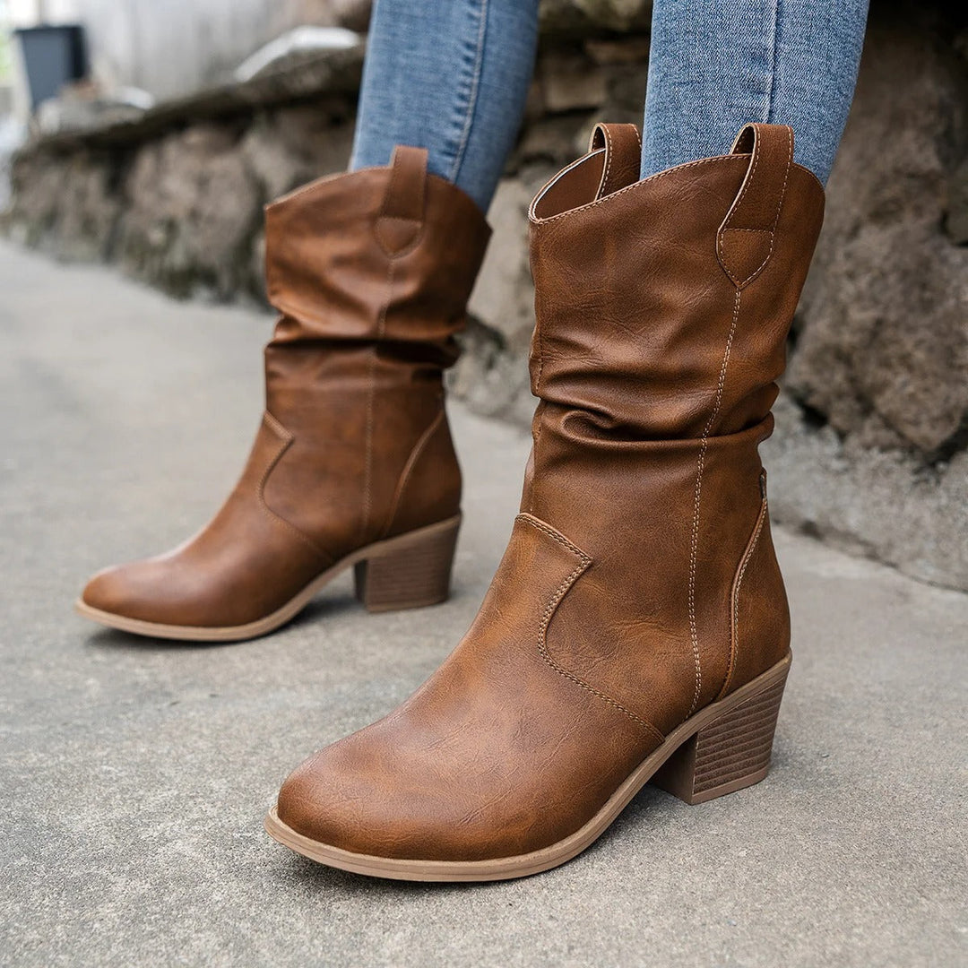 Stylish women's black leather heeled ankle boots, perfect for winter, fall, or dressy casual outfits.