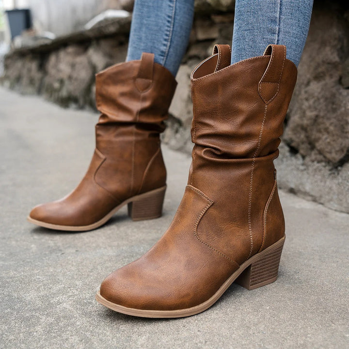 Stylish women's black leather heeled ankle boots, perfect for winter, fall, or dressy casual outfits.