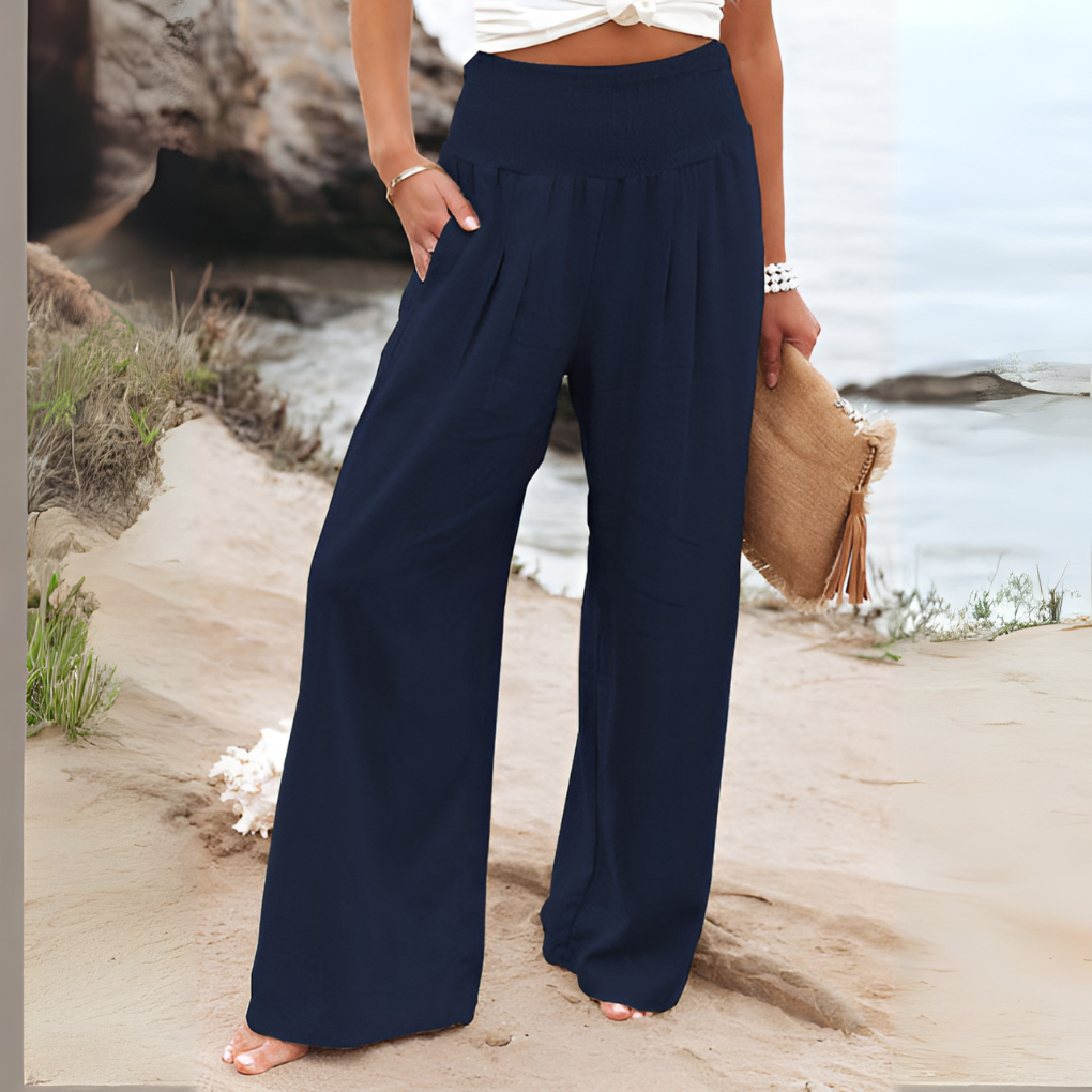 Woman walking in relaxed fit high-waisted stretch linen trousers, showing comfort & casual style.