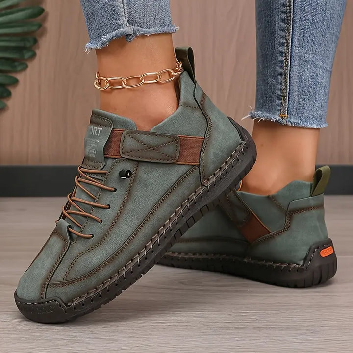 Side profile of a comfortable women's walking sneaker, highlighting its ergonomic sole design.