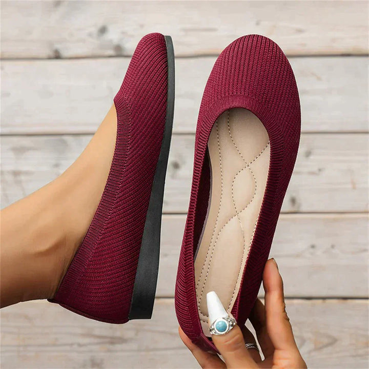 Women's fashionable red ballet flats, a vibrant choice for spring footwear.