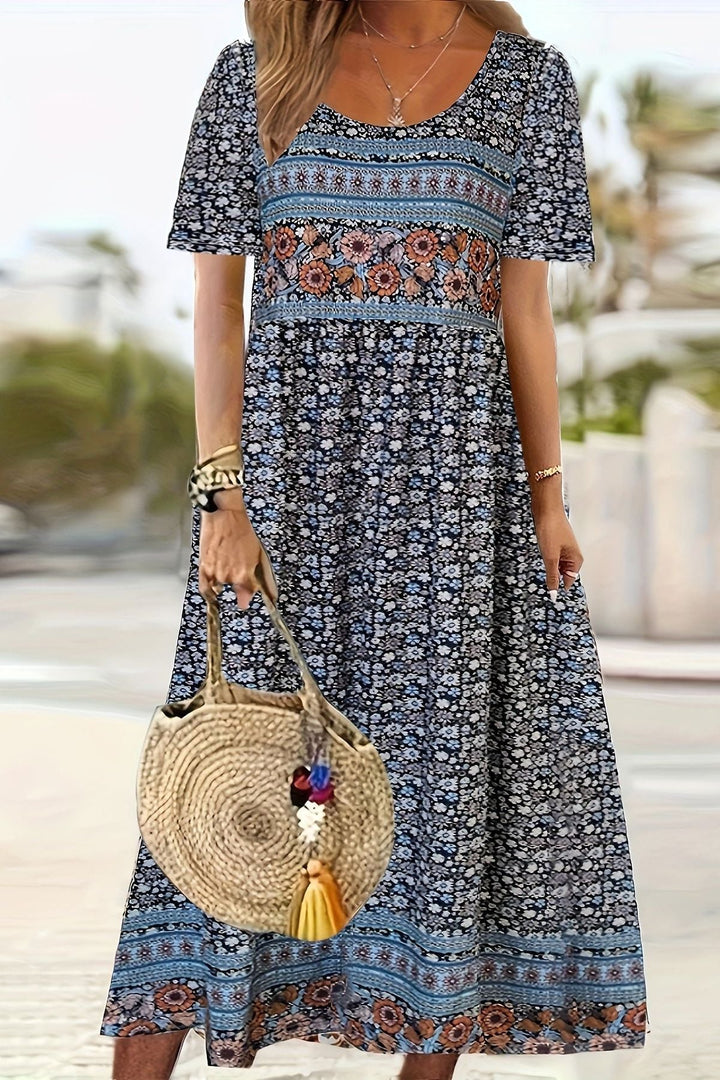 Soft, comfortable women's printed midi dress. Relaxed fit, knee-length, for an elegant summer or everyday look.