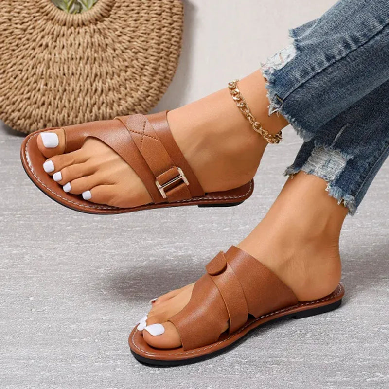 Elegant women's flat buckle sandals, designed for summer comfort. Open-toe slip-on casual & fashionable footwear.