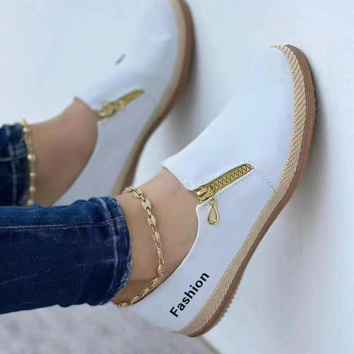 Side view of women's lightweight slip-on sneakers, featuring a flexible sole for comfortable everyday walking & style.