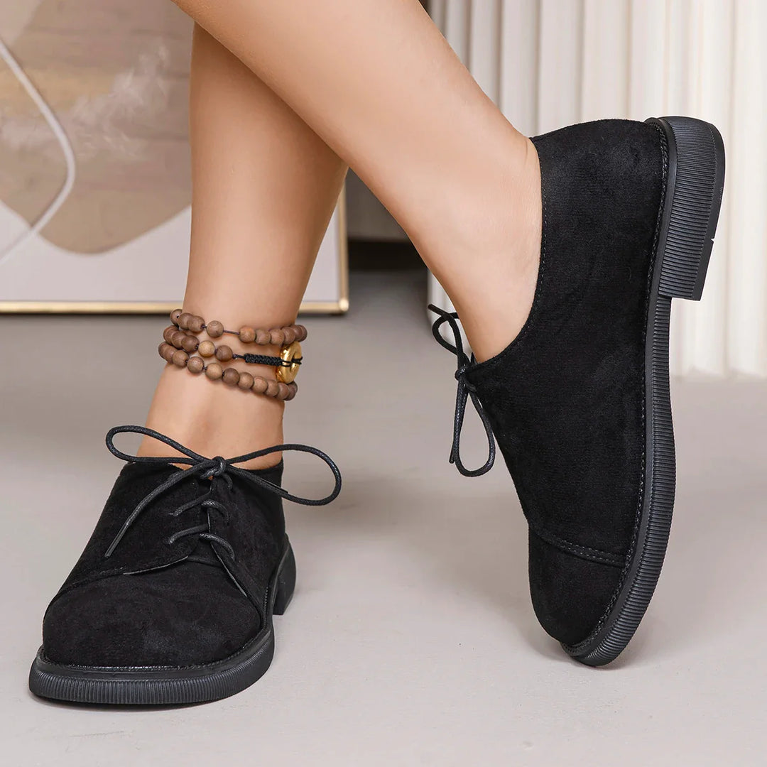 Lace-up women's orthopedic flats in a soft suede finish, offering arch support.