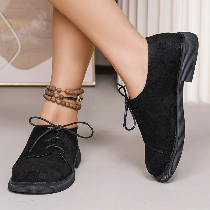 Lace-up women's orthopedic flats in a soft suede finish, offering arch support.