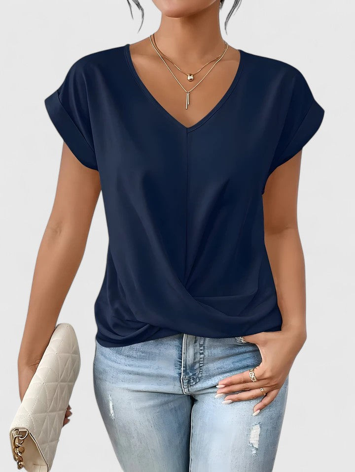 Fashionable summer top: comfortable women's V-neck with twist front. Chic casual blouse.