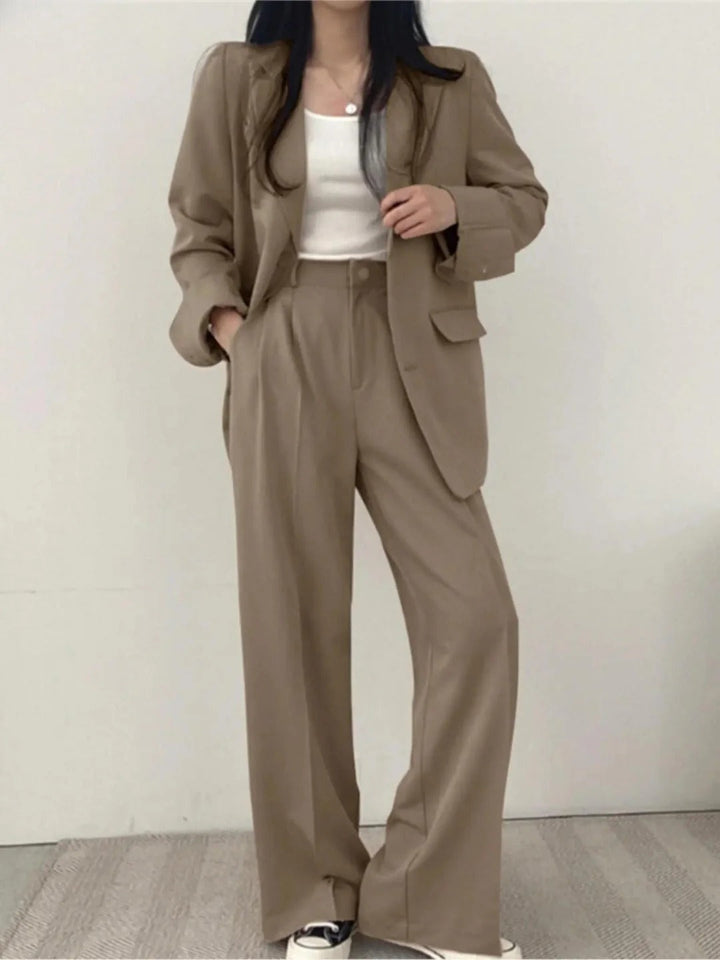 Modern women's two-piece suit featuring stretch blazer & trousers, offering comfort & chic style for many occasions.