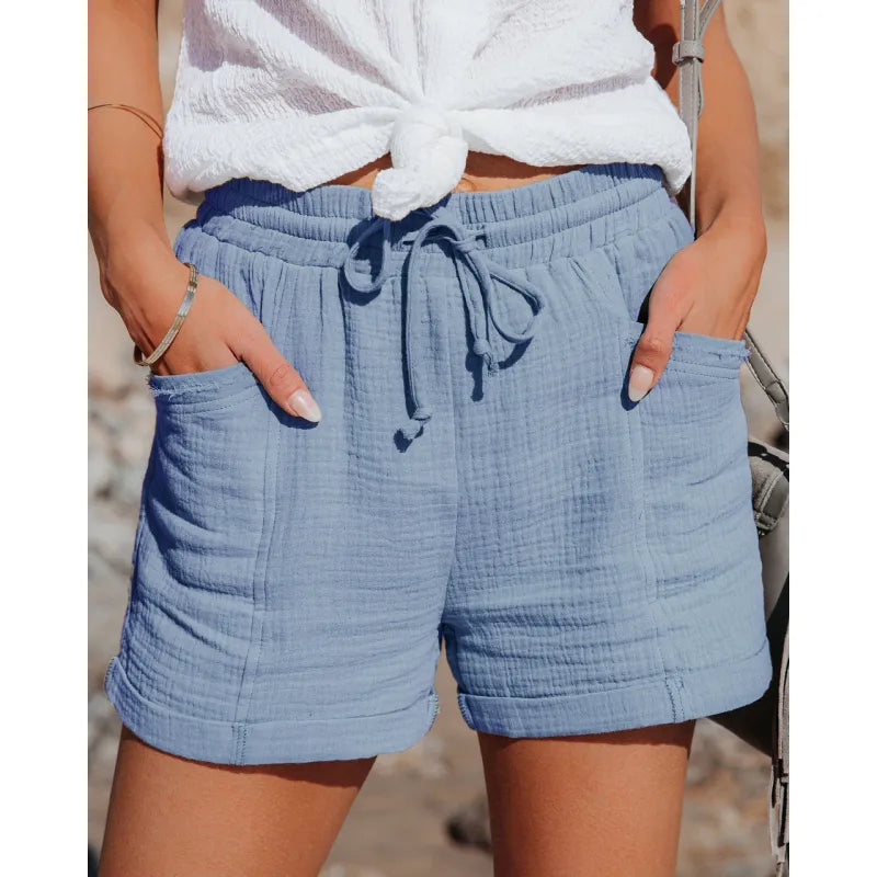 Elastic waist women's shorts, above knee length, with functional pockets. Ideal for casual summer outfits.