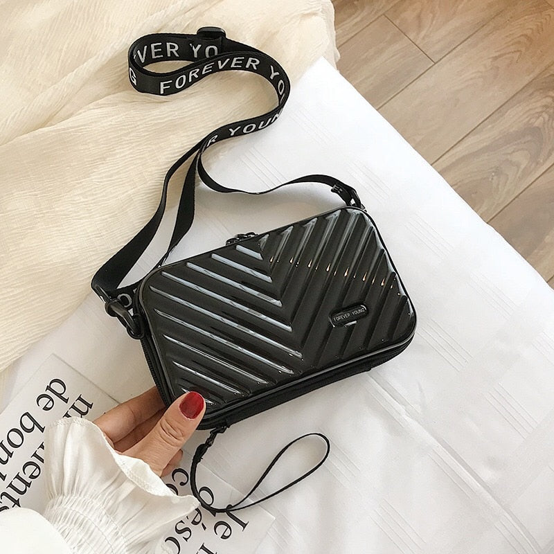 Stylish women's travel handbag, a durable hard shell mini shoulder bag for daily and travel use.