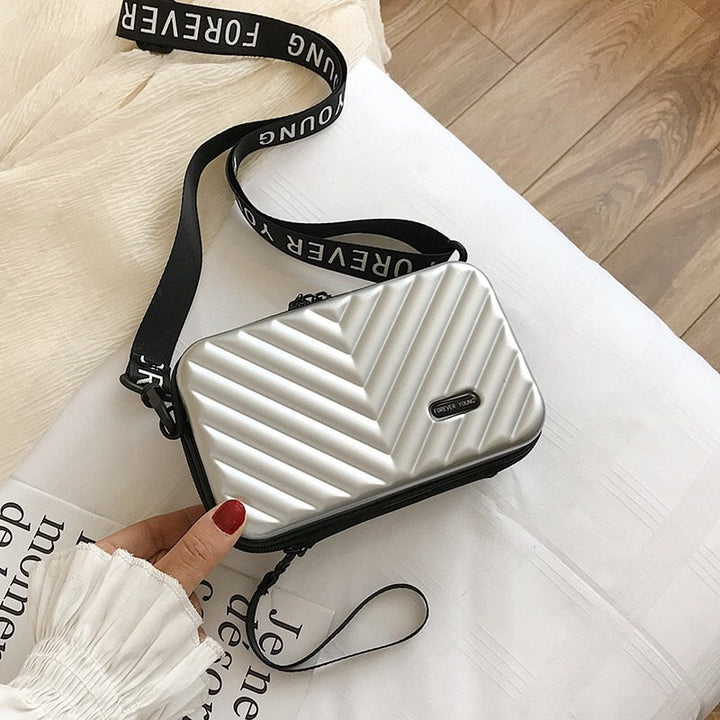 Elegant women's compact hard shell travel bag, a versatile everyday accessory for any outfit.