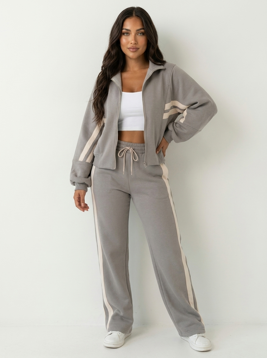 Sporty women's athletic tracksuit set. Zip-up jacket & wide leg pants with stylish contrast stripe.