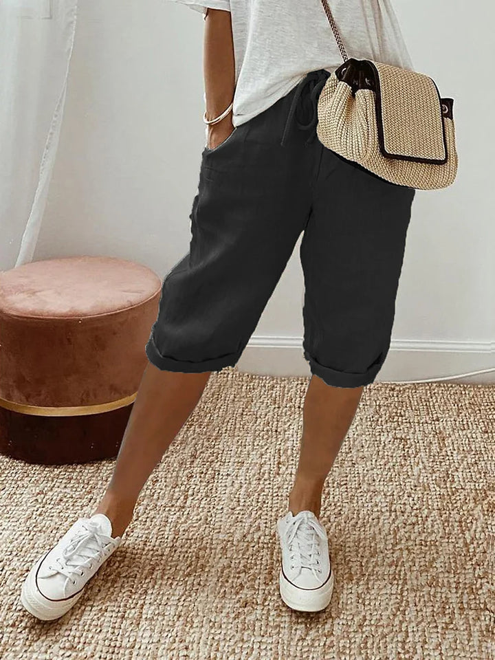 Women's cotton capri pants with drawstring waist & stylish roll hem. Perfect for casual summer comfort.