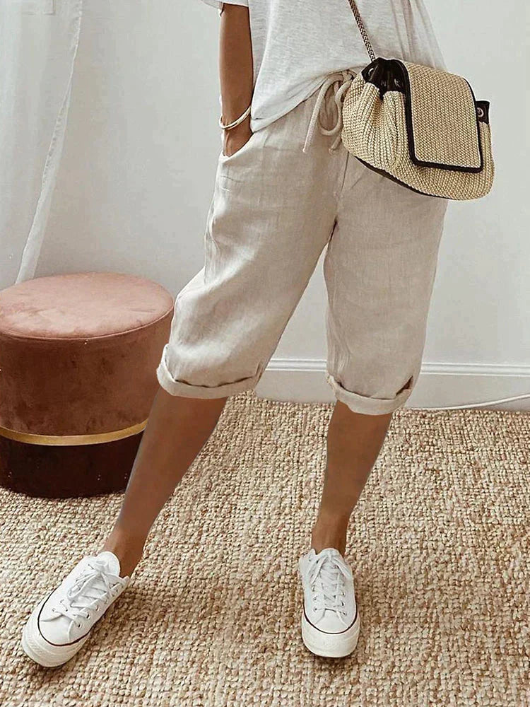 Comfortable women's relaxed fit cotton capri pants, featuring an adjustable drawstring waist & chic roll hem.