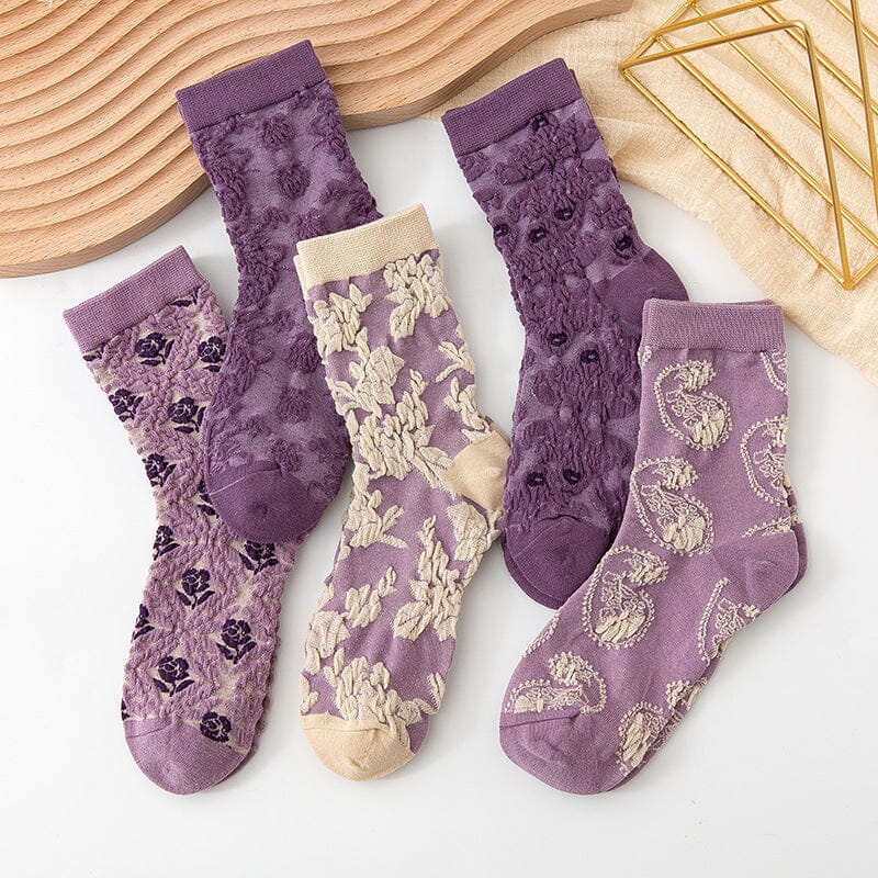 Stack of folded women's cotton socks featuring assorted floral designs, great as a gift pack