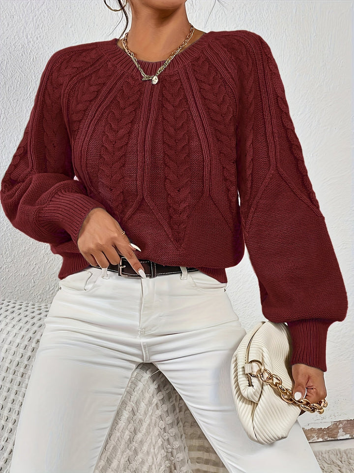 Women's cable knit sweater with relaxed fit, lantern sleeves, cozy for autumn evenings.
