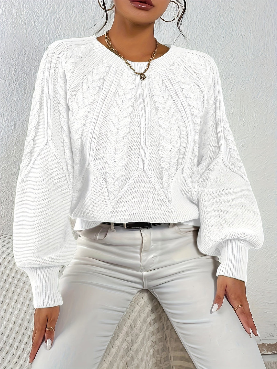 Women's relaxed fit cable knit sweater, cozy & fashionable, ideal for layering.