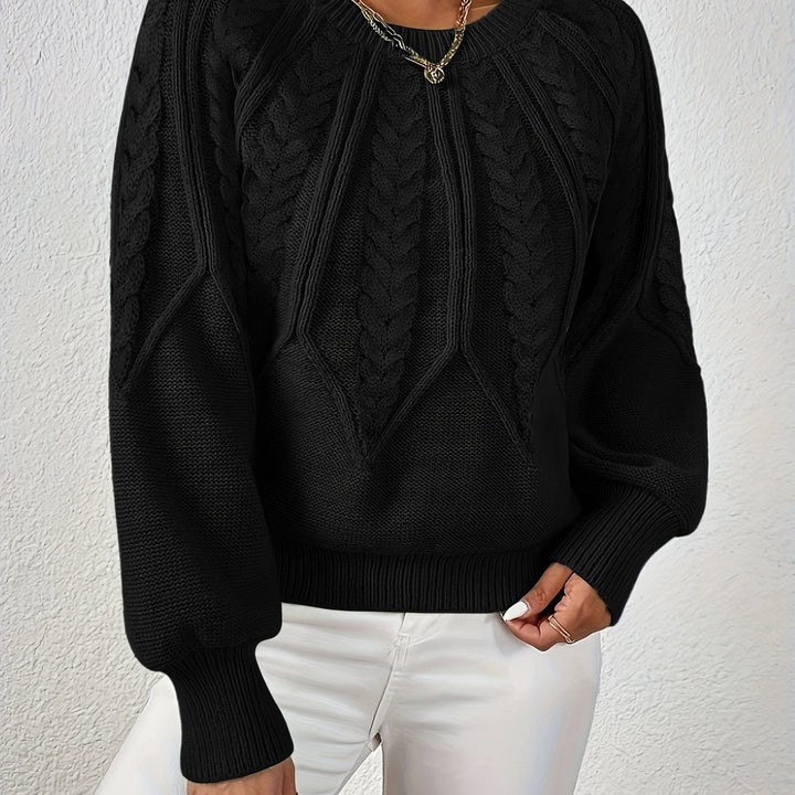 Women's elegant cable knit sweater, relaxed fit, with beautiful sleeve detail.