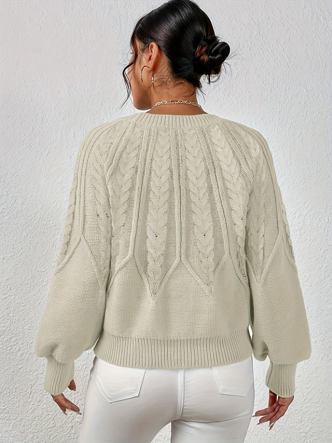 Warm women's lantern sleeve cable knit sweater, relaxed fit, a winter fashion staple.