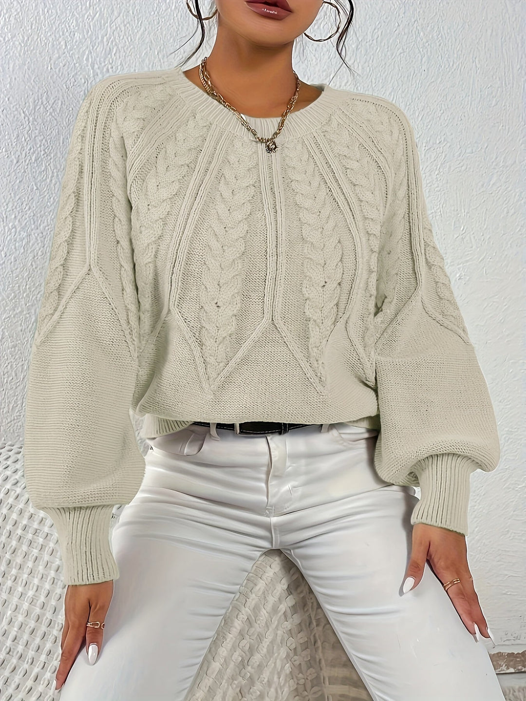 Women's stylish relaxed fit cable knit sweater, soft texture, great for layering.