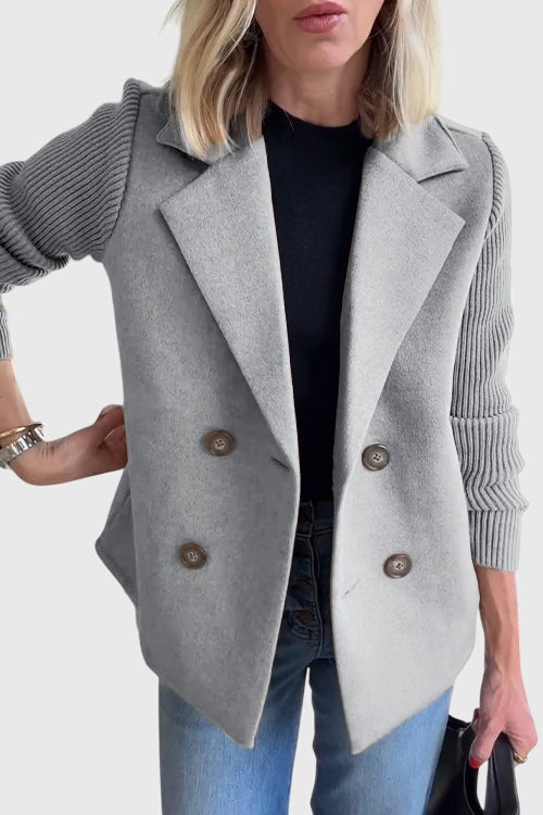 Woman wearing a stylish double-breasted knit blazer, a versatile piece for chic office or weekend outfits.
